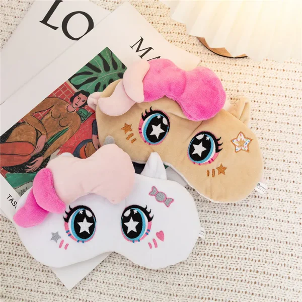 Beige and white cute unicorn plush sleep masks with pink 3D manes, embroidered star eyes and candy details for night sleep.