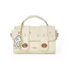 Front view of the cream MESUCA x Disney satchel bag featuring a pink polka dot flap, gold hardware, and an embroidered Mickey glove charm.
