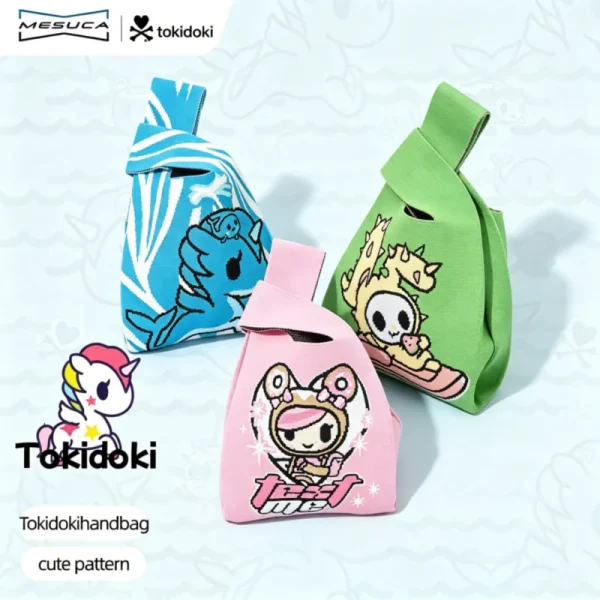 Three cute Tokidoki knit wristlet bags in blue, pink and green with cartoon unicorn, cat girl and dragon patterns.
