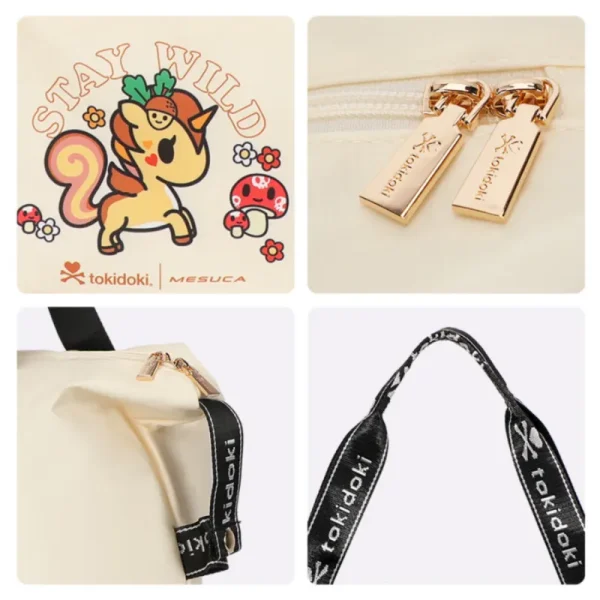 Close-up details of a cream Tokidoki travel bag featuring a cute 'Stay Wild' unicorn print, premium gold metal zippers, and branded black shoulder straps.