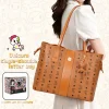 Woman in white blouse carrying a cognac brown Tokidoki unicorn print vegan leather tote bag on her shoulder with gift box.