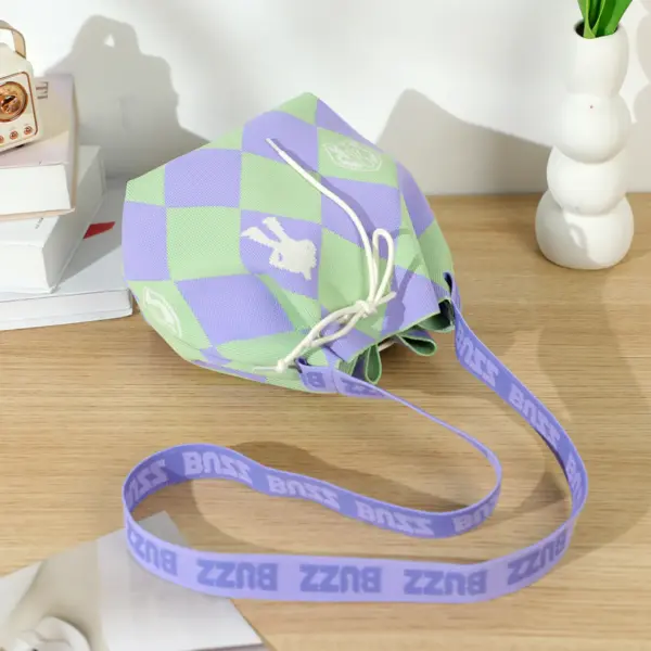 Lifestyle shot of a pastel Toy Story themed knit bag on a wooden desk next to books and a vase, soft lighting.