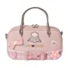 Direct front shot of a pastel pink mini tote bag with embroidered sheep face wearing glasses, lace trim, bow tie, crochet flowers, and "BELLWETHER" text.