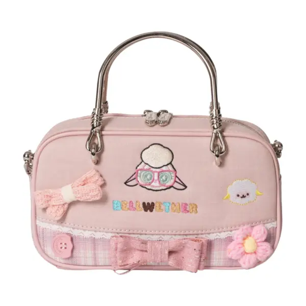 Direct front shot of a pastel pink mini tote bag with embroidered sheep face wearing glasses, lace trim, bow tie, crochet flowers, and "BELLWETHER" text.