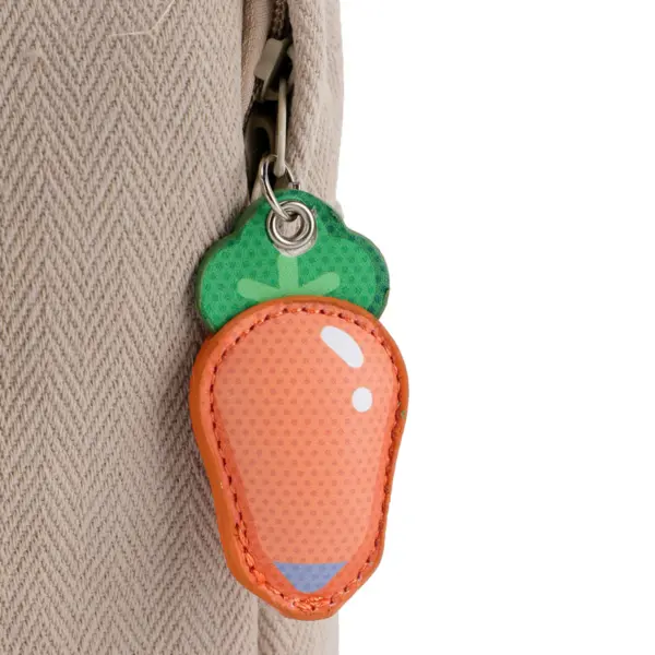 Close-up view of the cute orange carrot-shaped leather zipper pull attached to the side pocket of the Judy Hopps themed rucksack.