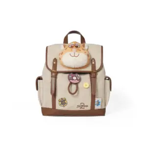Front angle of a beige herringbone canvas backpack with a soft orange spotted cheetah plush face and a pink donut charm attached to the strap.