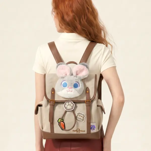 A woman wearing a Zootopia themed mini backpack with bunny ears and patches, showcasing the preppy academia style.