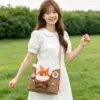 Young woman in a white dress walking outdoors, modeling a brown microfiber tote bag featuring a plush fox head design.