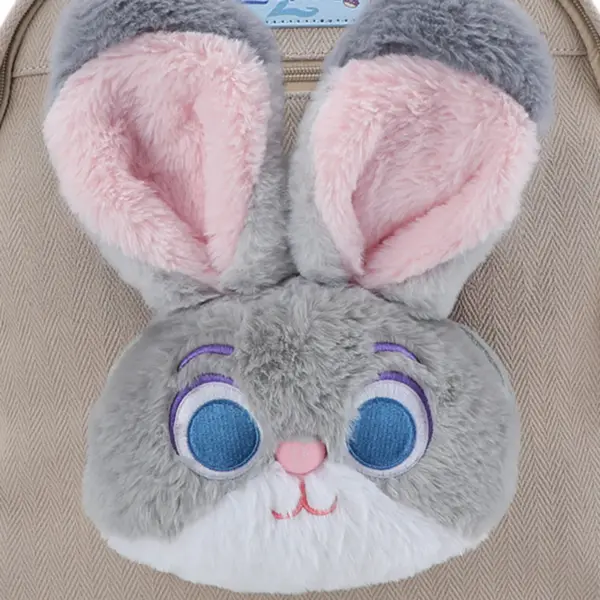 Extreme close-up of the ultra-soft faux fur texture on Judy Hopps' big blue eyes and pink-lined ears, emphasizing the cozy quality of the bag.