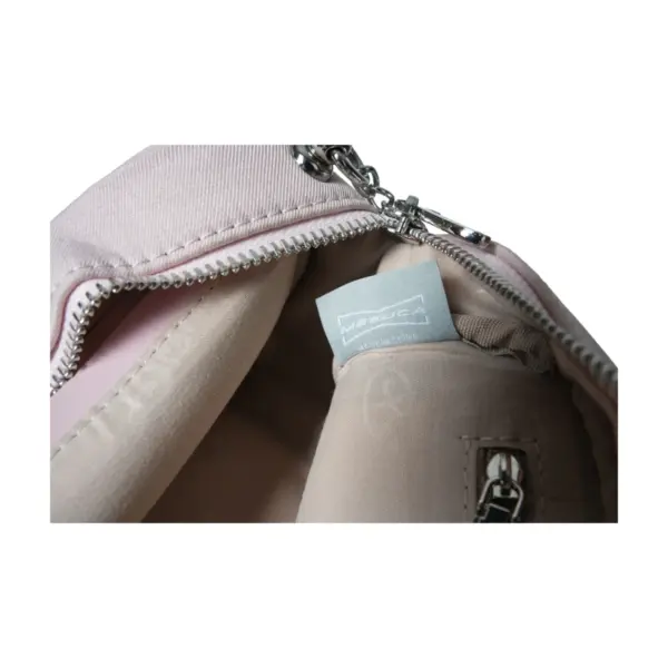 Close-up of the interior lining showing the authentic "MESUCA MADE IN CHINA" woven label tag and Disney embossed fabric.