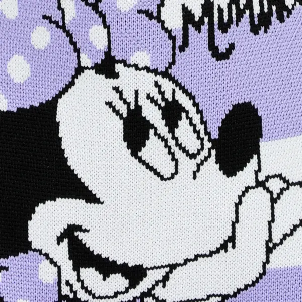 Extreme close-up of the woven Minnie Mouse face and polka dot bow pattern on purple knit fabric.
