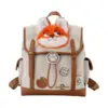 Front view of a beige canvas backpack with Nick Wilde plush head, "Junior ZPD Officer" badge, and donut accessory.
