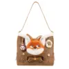 Flat lay product shot of a chocolate brown hobo bag with a large 3D orange fox face, bow tie accent, and cloud trim.