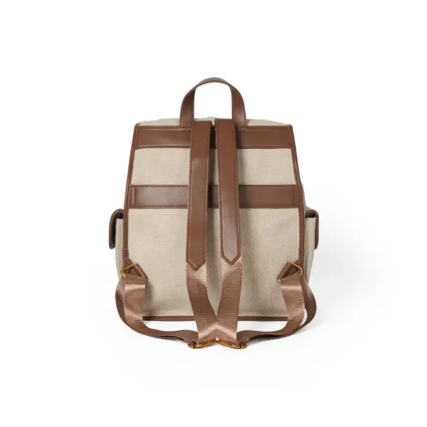 Rear view of the canvas rucksack focusing on the comfortable padded leather-like shoulder straps and top grab handle.