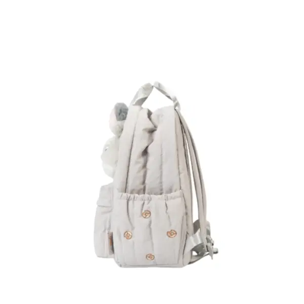 Angled rear view showing the quilted texture, side water bottle pocket, and adjustable straps of the Zootopia themed mini backpack.