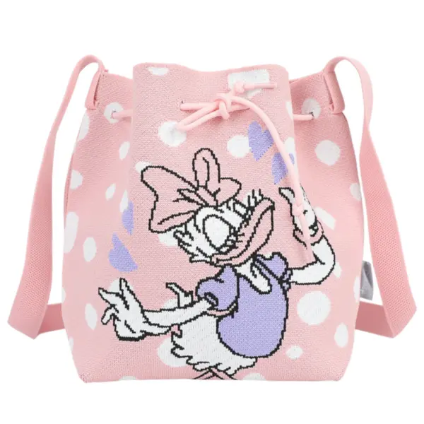 Front view of a pink knit bucket bag with white polka dots and a large Daisy Duck graphic in a purple dress.
