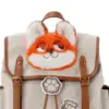 Close-up of the soft orange and white faux fur Nick Wilde applique on the flap of a canvas backpack.