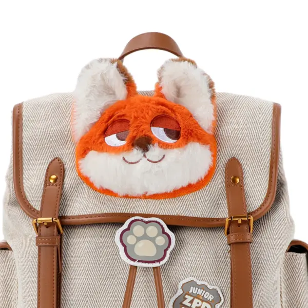 Close-up of the soft orange and white faux fur Nick Wilde applique on the flap of a canvas backpack.
