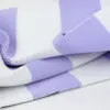 Close-up of breathable lavender and white striped knit fabric showing the woven mesh texture.