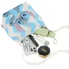 Flat lay showing the capacity of a small Stitch bucket bag holding a phone, umbrella, perfume, and makeup compact.