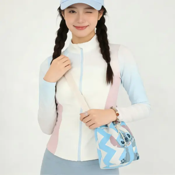 A woman wearing a blue Stitch knit crossbody bag with a wide shoulder strap, paired with sporty casual outfit.