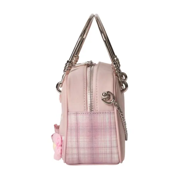 Side profile of a pink canvas doctor bag featuring plaid patchwork, silver metal handle, and chain strap details.