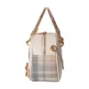 Side profile of a cream canvas doctor bag featuring plaid patchwork, gold metal handle, and chain strap details.