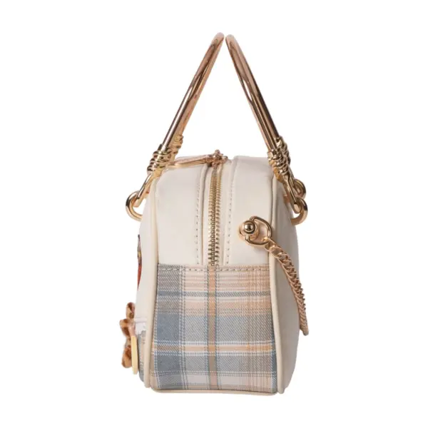 Side profile of a cream canvas doctor bag featuring plaid patchwork, gold metal handle, and chain strap details.