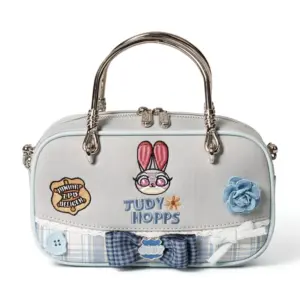 Direct front shot of a light grey canvas mini tote bag with embroidered bunny face, ZPD badge patch, lace trim, bow tie, blue fabric rose, and "JUDY HOPPS" text.