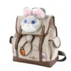 Side angle of a beige herringbone backpack featuring a plush Judy Hopps face, brown leather straps, and carrot pen holder.