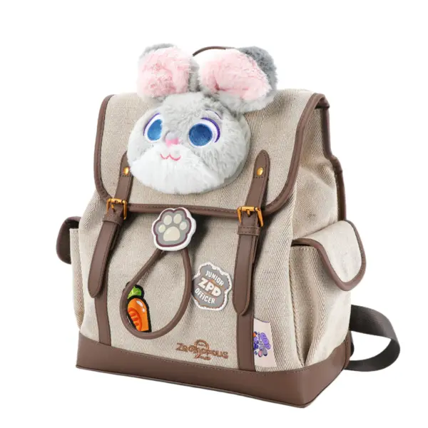 Side angle of a beige herringbone backpack featuring a plush Judy Hopps face, brown leather straps, and carrot pen holder.