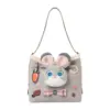 Front view of a light grey faux suede shoulder bag featuring a plush Judy Hopps bunny face, carrot charm, and "Donut Worry" embroidery patch.