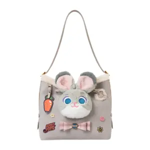 Front view of a light grey faux suede shoulder bag featuring a plush Judy Hopps bunny face, carrot charm, and "Donut Worry" embroidery patch.