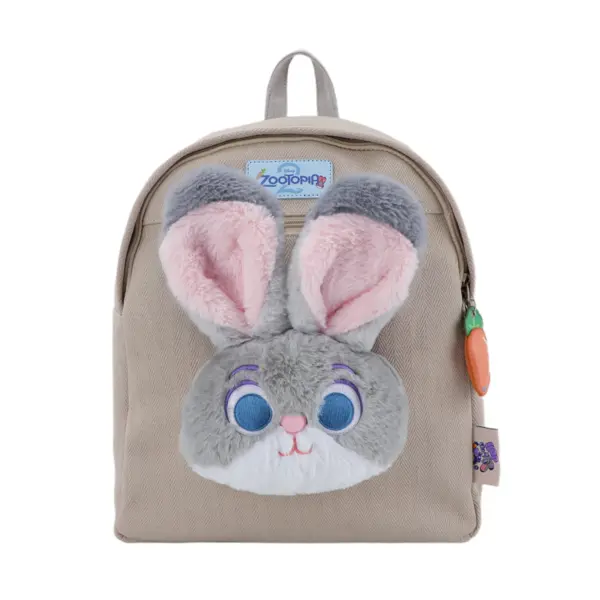 Direct front shot of a light beige herringbone canvas mini backpack featuring a large 3D plush Judy Hopps bunny face with big ears and a carrot zipper charm.