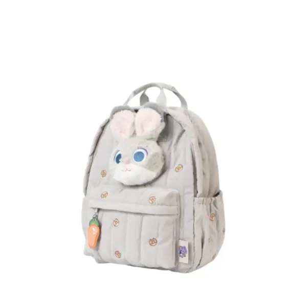 Side profile of a light grey puffy backpack featuring plush bunny ears, carrot charm, and donut embroidery details.