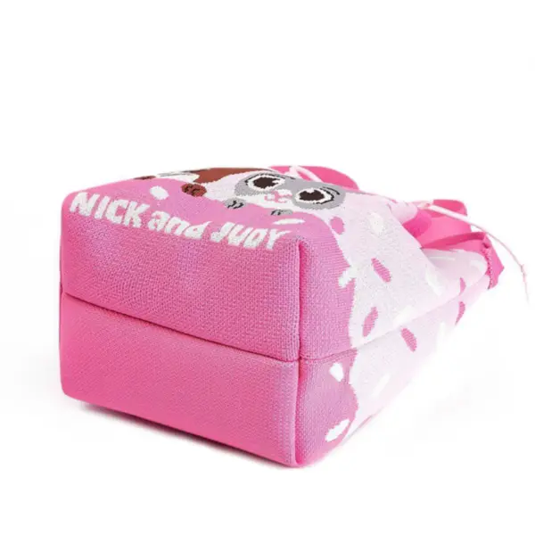 Bottom view of a pink knit bucket bag showing the structured base and "Nick and Judy" text woven into the fabric.